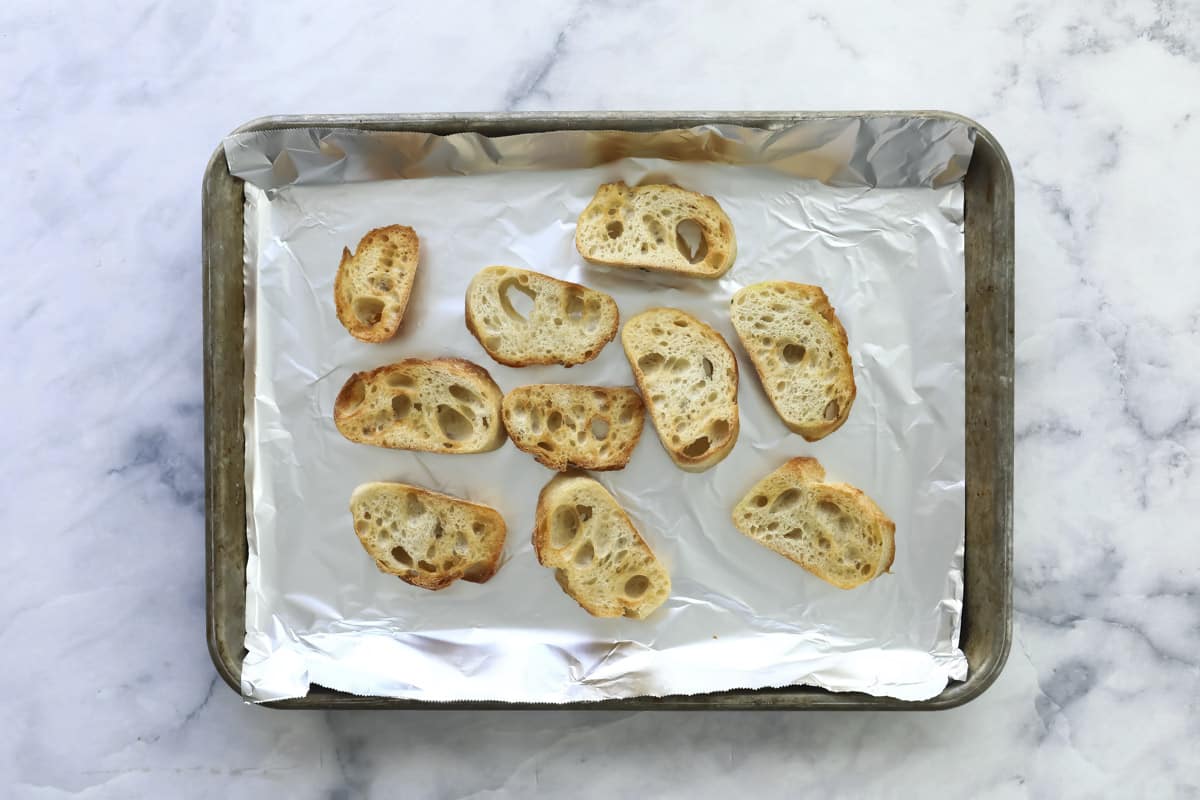 Toasted bread on a sheet tray.