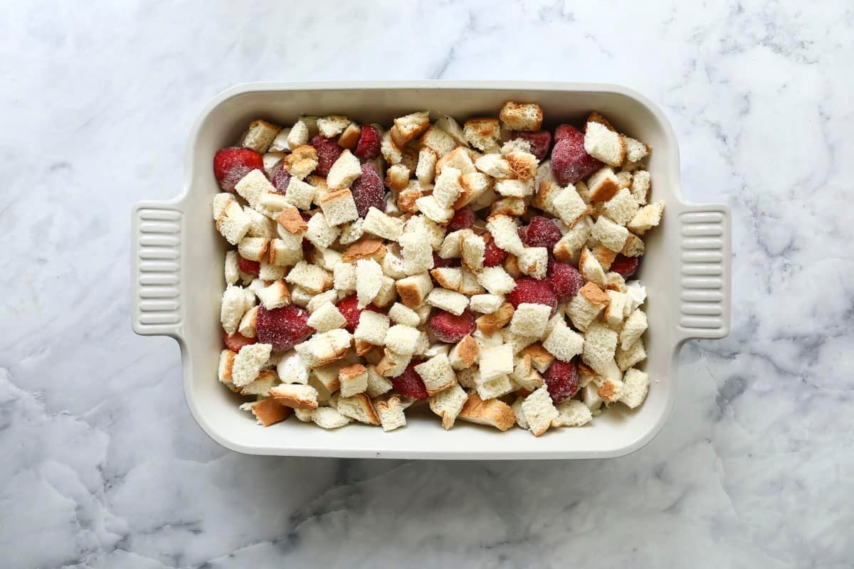 An unbaked dish of strawberry French toast casserole.