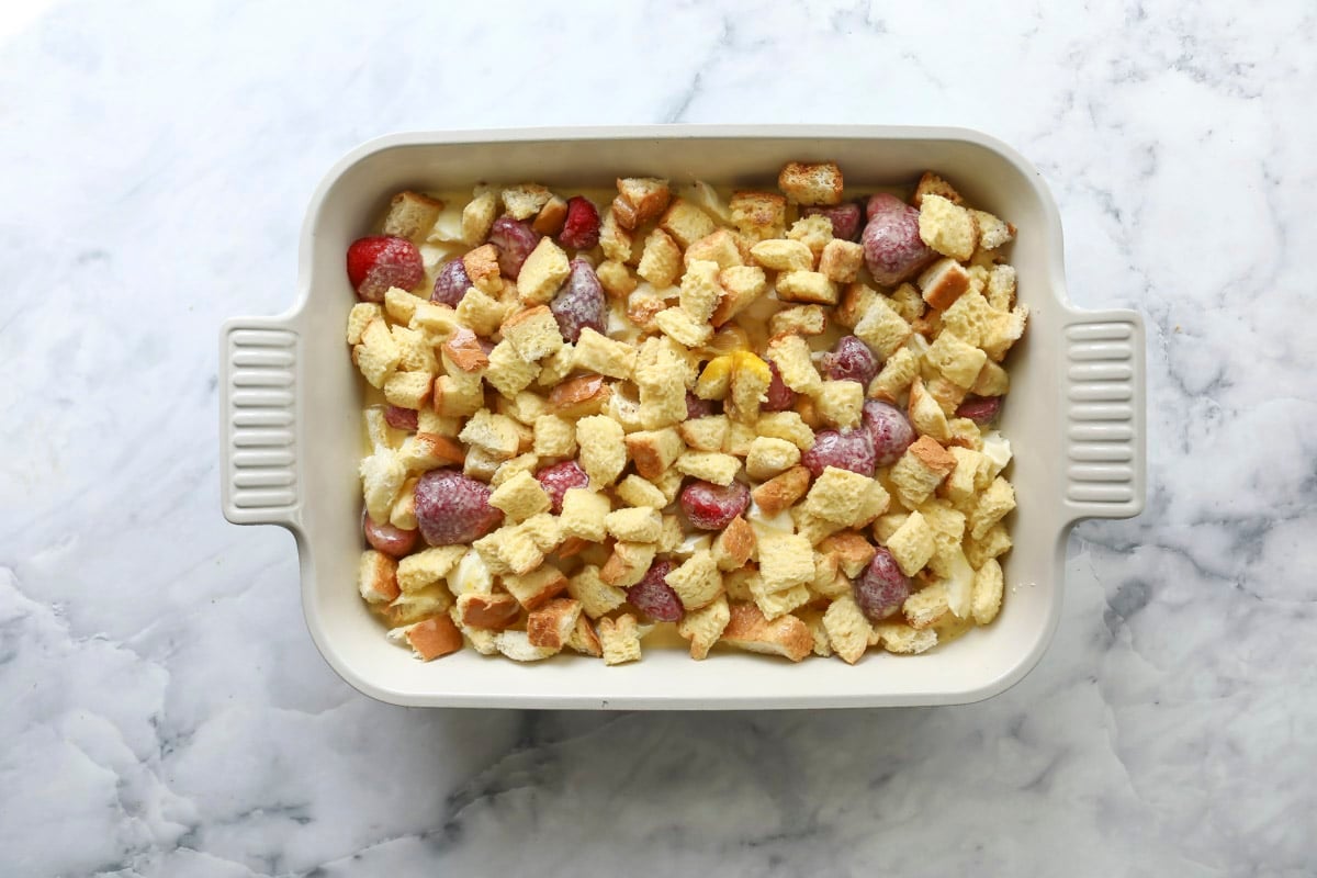 An unbaked dish of strawberry French toast casserole.