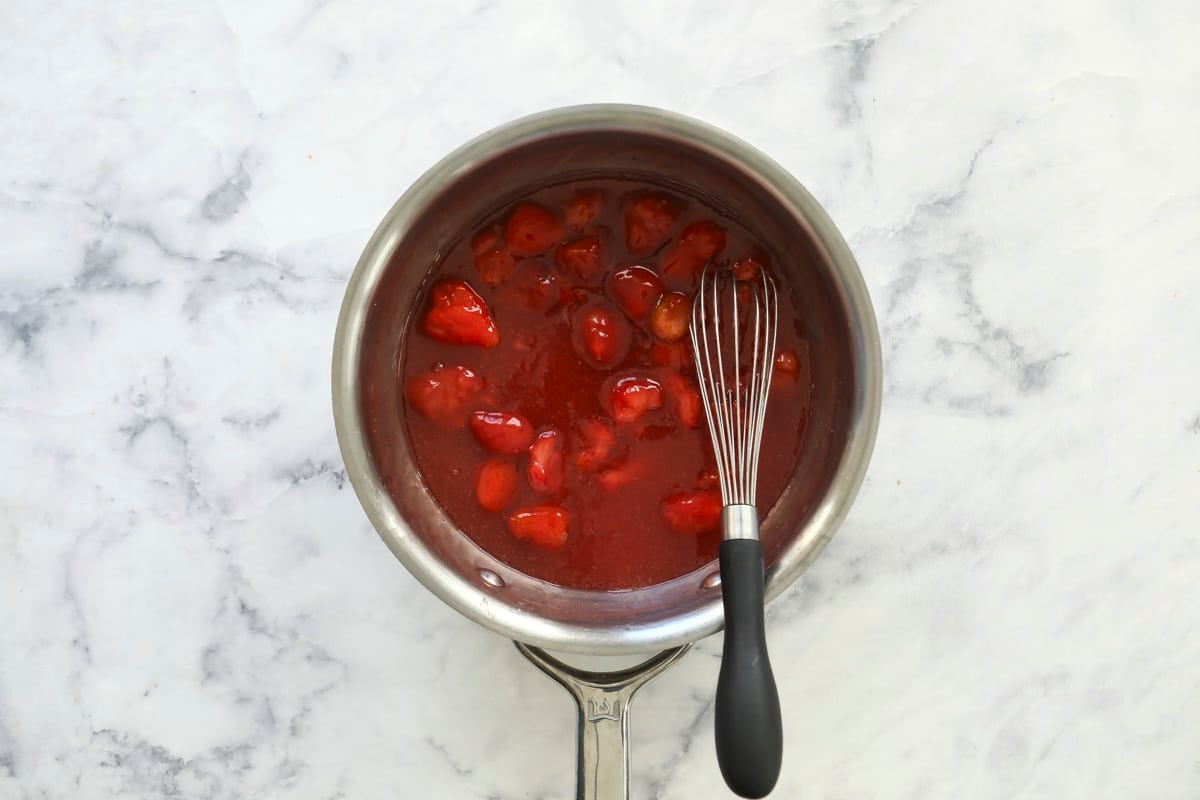 A saucepan of strawberry topping.