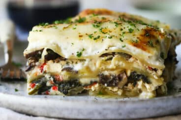 A piece of vegetable lasagna on a plate.