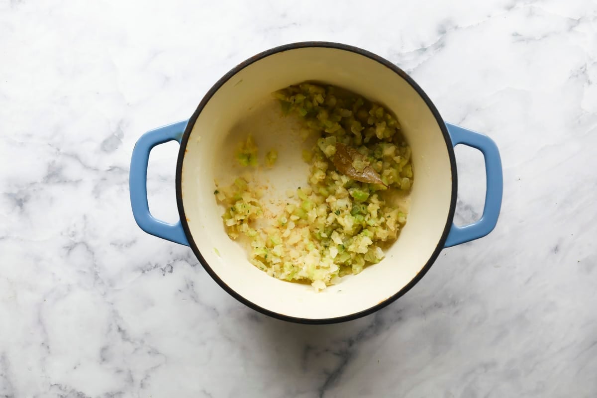 Vegetables softening in a pot.